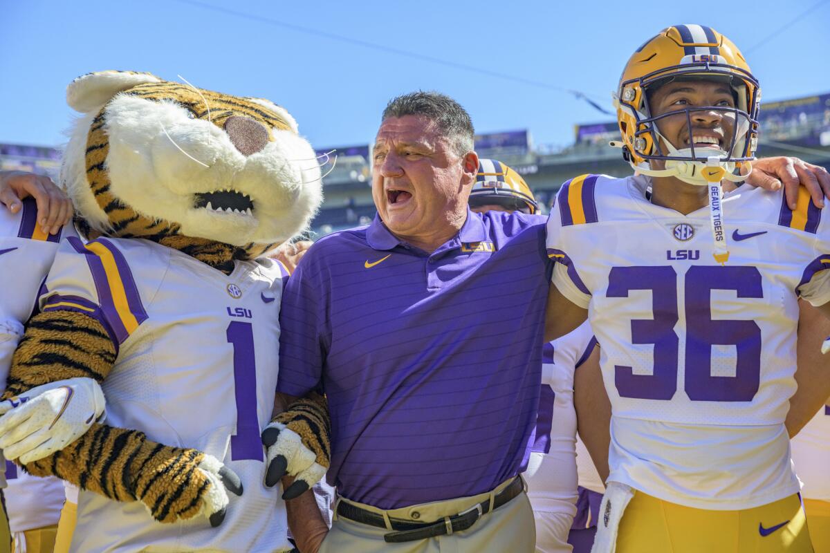 LSU coach Ed Orgeron celebrates his team's 49-42 victory against Florida 