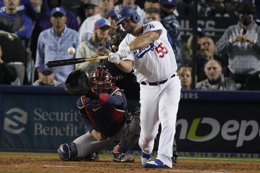 Los Angeles Dodgers' Albert Pujols singles in the seventh inning against the Atlanta Braves in Game 4 of baseball's National League Championship Series Wednesday, Oct. 20, 2021, in Los Angeles. (AP Photo/Marcio Jose Sanchez)