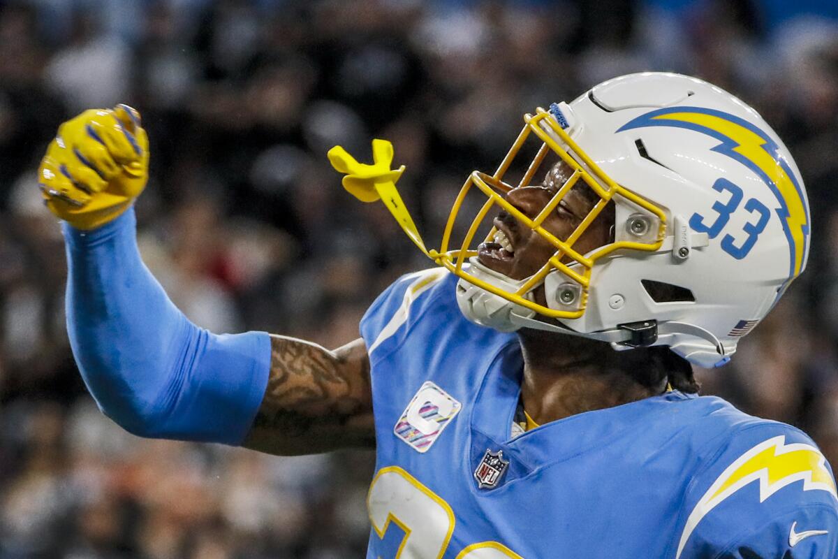 Chargers free safety Derwin James celebrates after teammates sack Raiders quarterback Derek Carr during a back on Oct. 4.