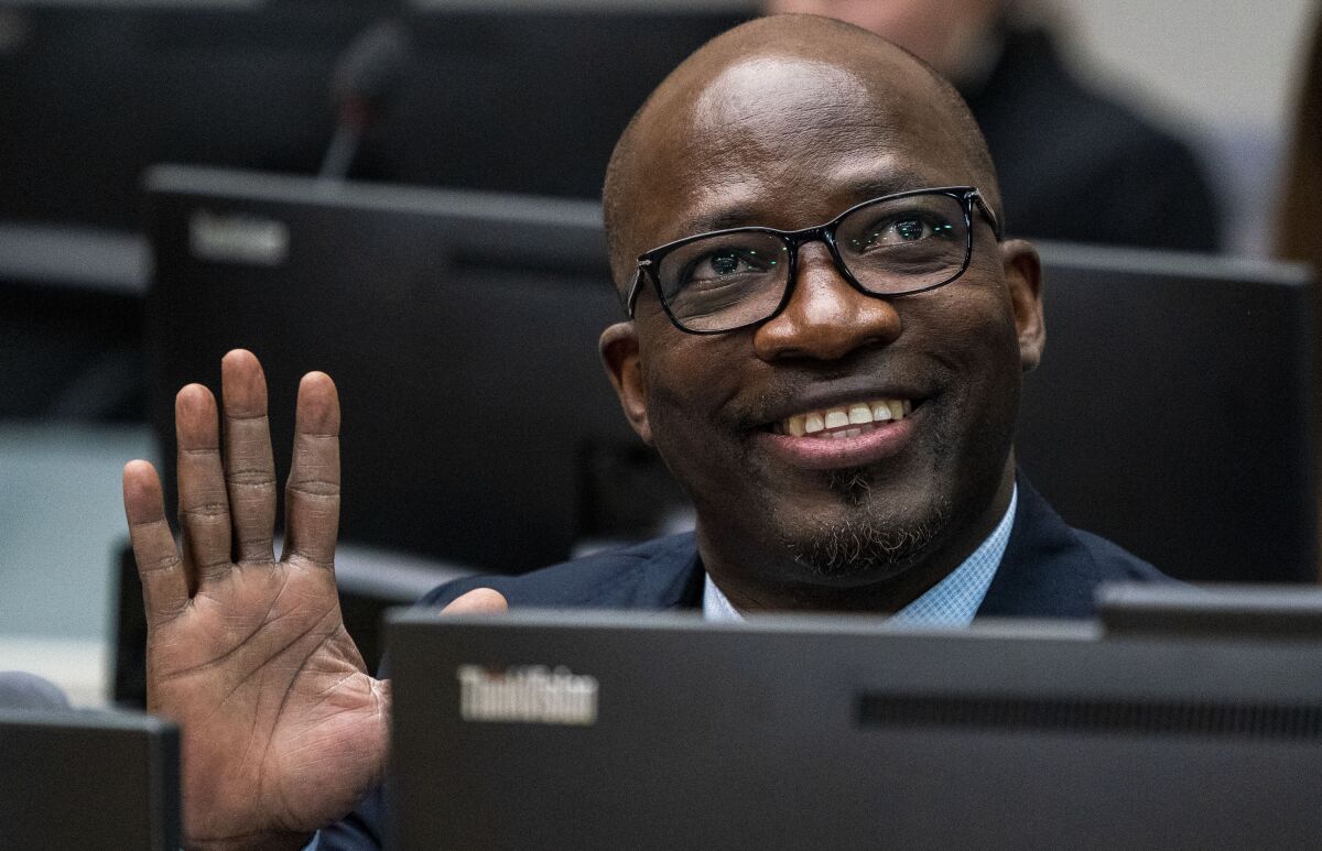 FILE - Ivory Coast politician and businessman Charles Ble Goude waves to supporters attending the appeals hearing at the International Criminal Court in The Hague, Netherlands, Feb. 6, 2020. International Criminal Court judges have on Thursday, Feb. 10, 2022 rejected a senior Ivory Coast politician’s claim for compensation after he was acquitted of involvement in deadly violence that broke out after elections in 2010. Former Youth Minister Charles Ble Goude was cleared in 2019, along with former president Laurent Gbagbo, of responsibility for crimes including murder, rape and persecution following the disputed elections. (Jerry Lampen/Pool photo via AP, file)