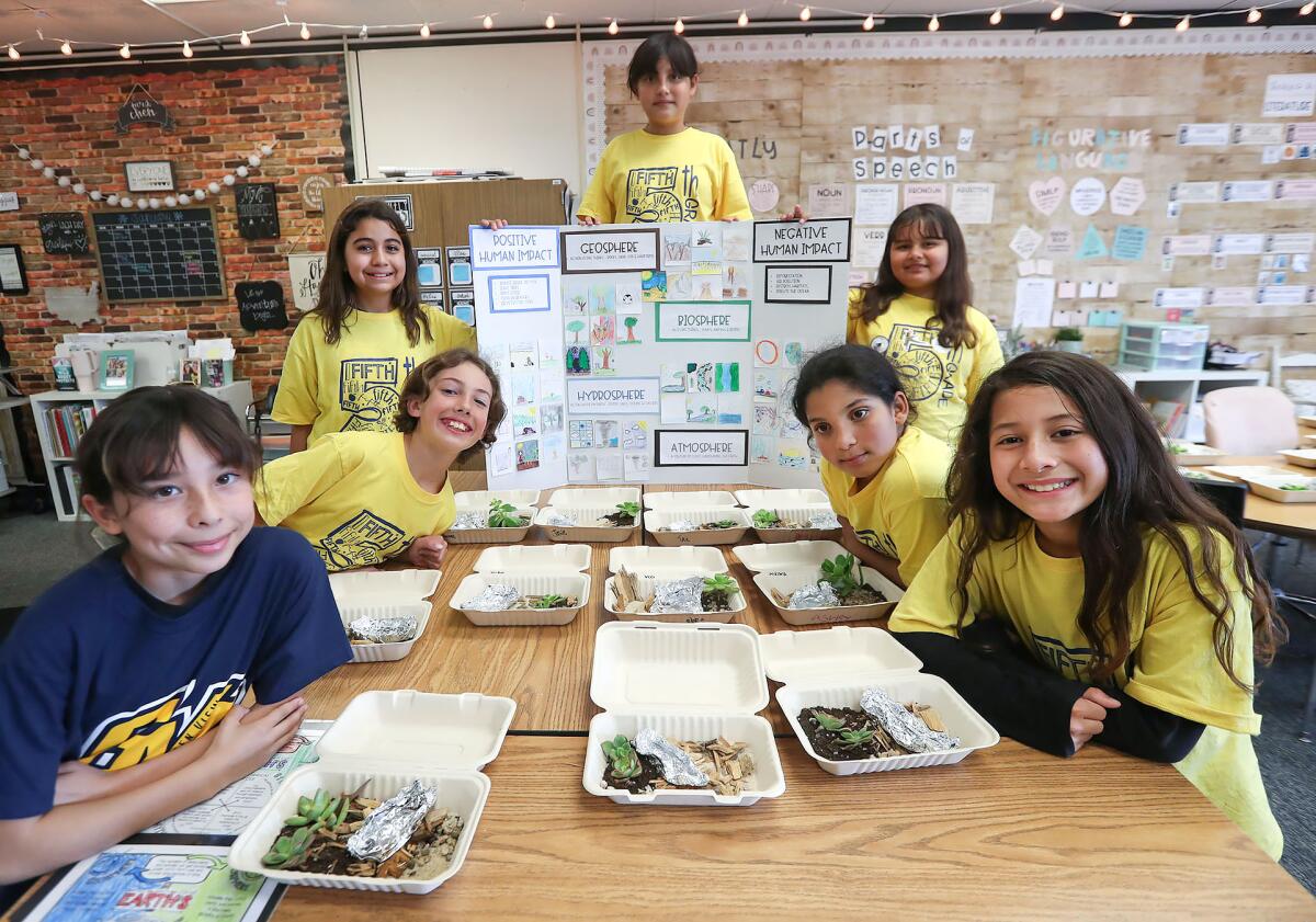 Students from Kindra Chen's fifth-grade classroom show their Human Environmental Impact poster.