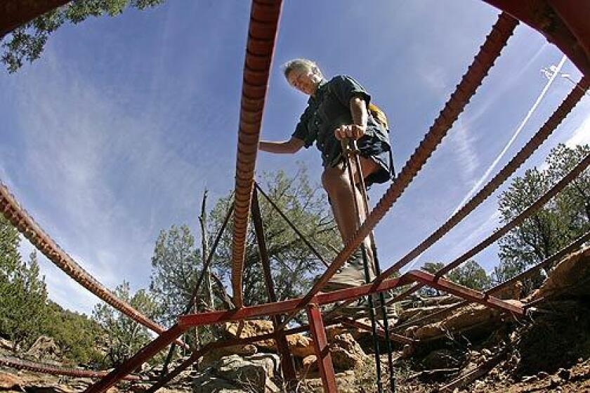 Lynell Schalk,a former BLM law enforcement official, crosses an illegal bridge recently installed in Recapture Canyon, near Blanding Utah, that allows off-road vehicle access.