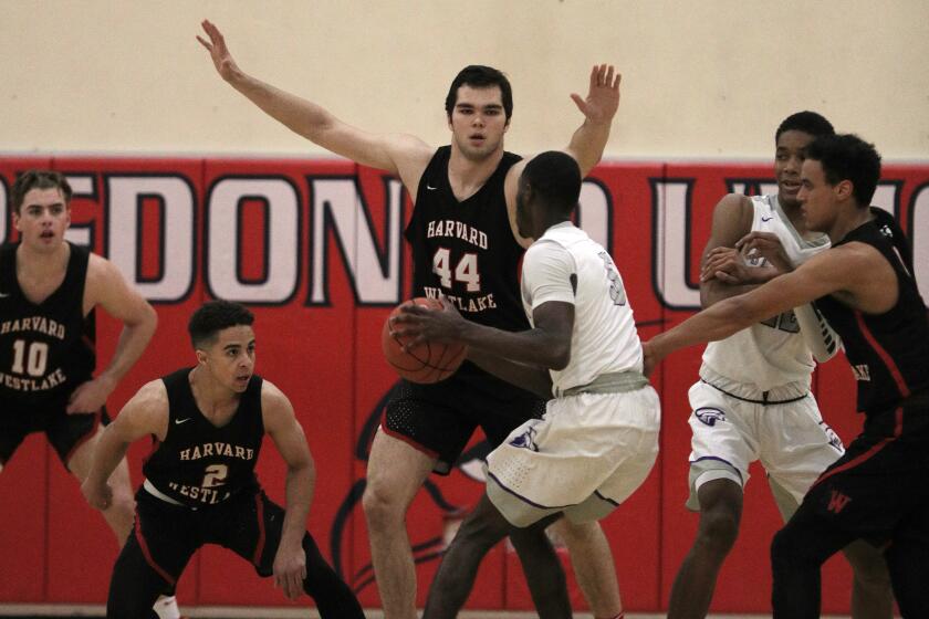 Harvard-Westlake center Mason Hooks (44) stops a drive by a St. Anthony players during a game at Redondo Union High on Jan. 4, 2020.