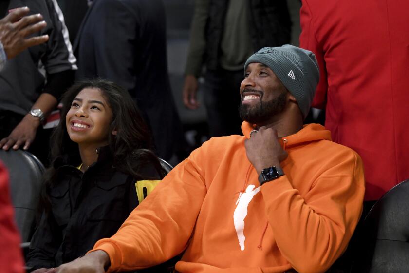 Former Los Angeles Laker Kobe Bryant and his daughter Gianna Bryant attend an NBA basketball game between the Los Angeles Lakers and Dallas Mavericks Sunday, Dec. 29, 2019, in Los Angeles. (AP Photo/Michael Owen Baker)
