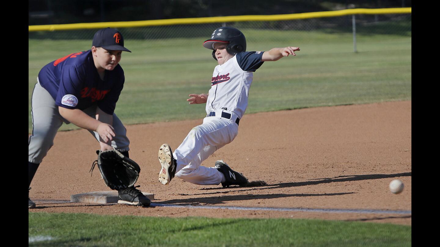 Newport Harbor Baseball Association's Bode Stefano, right, steals third base against Placentia B during the first inning in a PONY Bronco 11-and-under District tournament at Bonita Canyon Sports Park in Newport Beach on Friday, June 22.