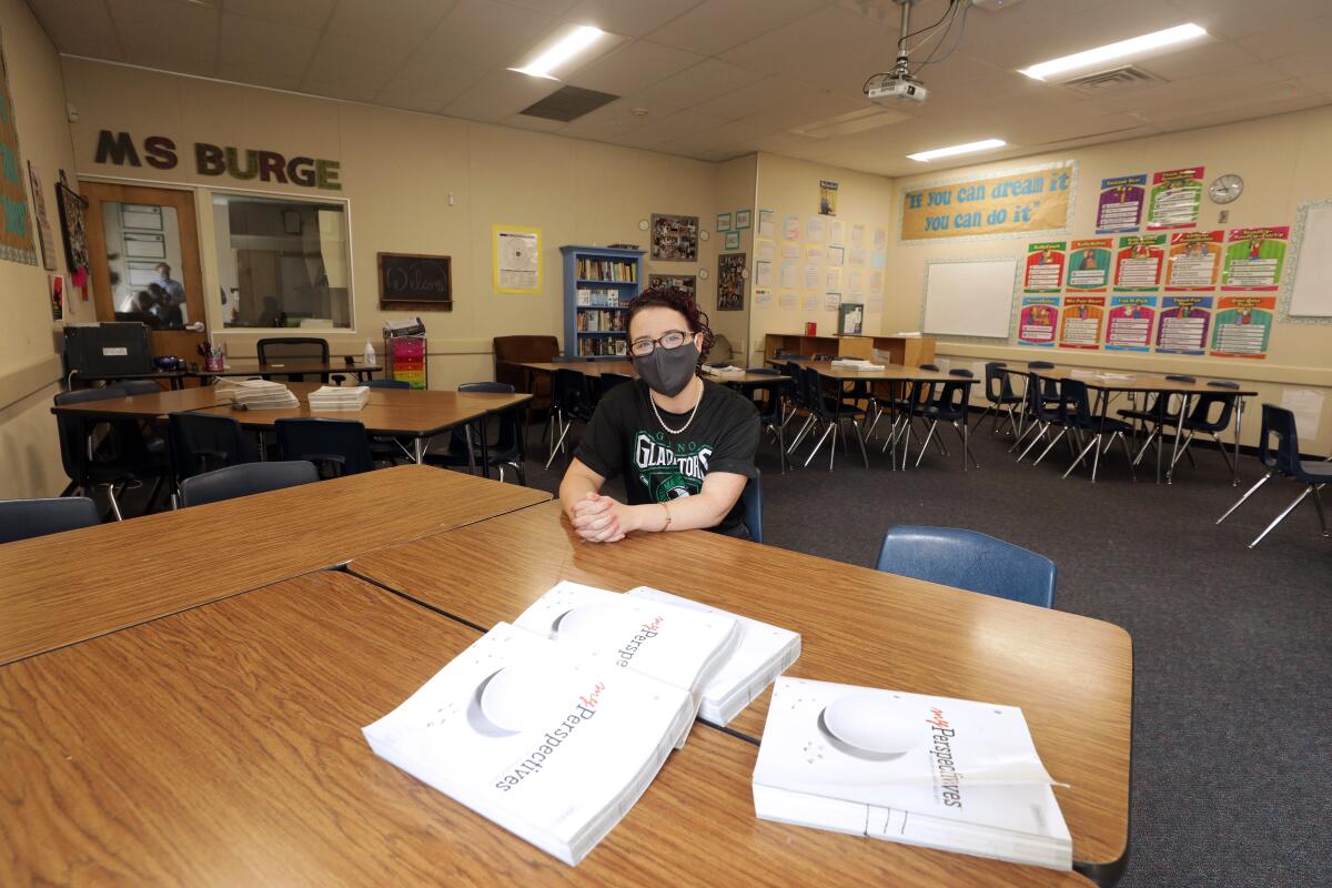 Natalie Burge, a teacher at Giano Intermediate School in West Covina, wears a mask in her empty classroom.
