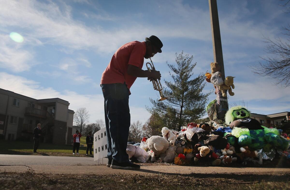 Eugene Gillis plays a trumpet last month at the memorial to Michael Brown in Ferguson, Mo.