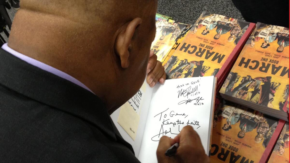 Rep. John Lewis signs a copy of "March: Book One" at Comic-Con in San Diego in 2013.