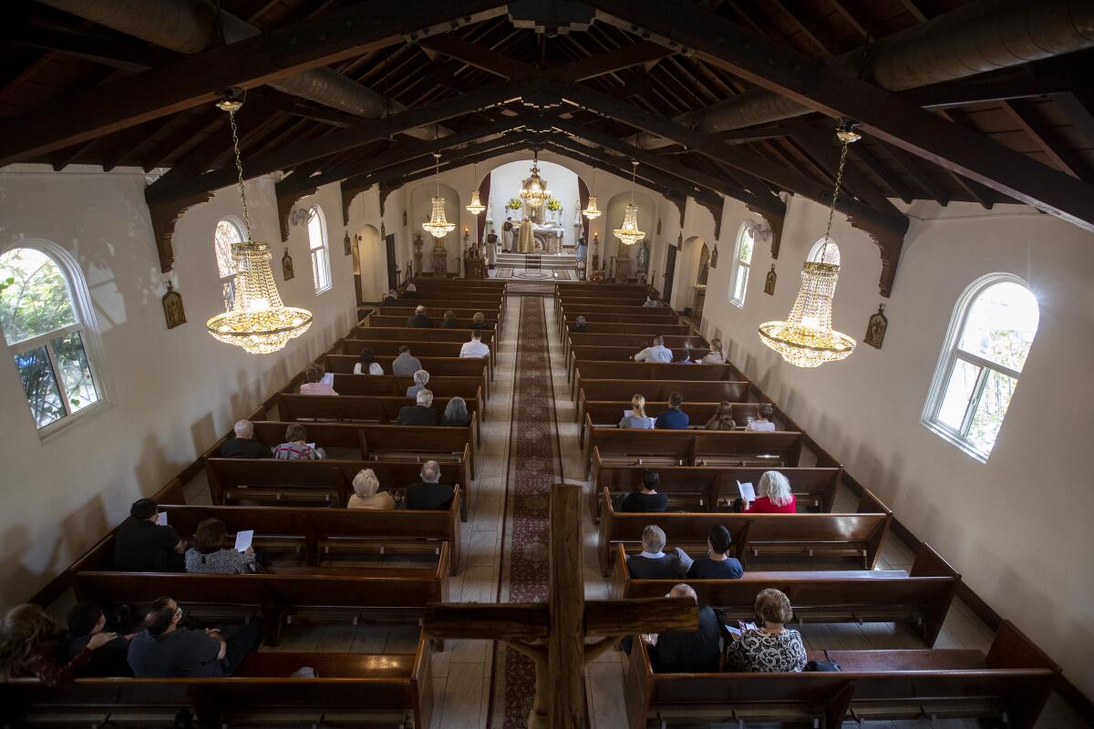 Congregants sit in church pews during a service.