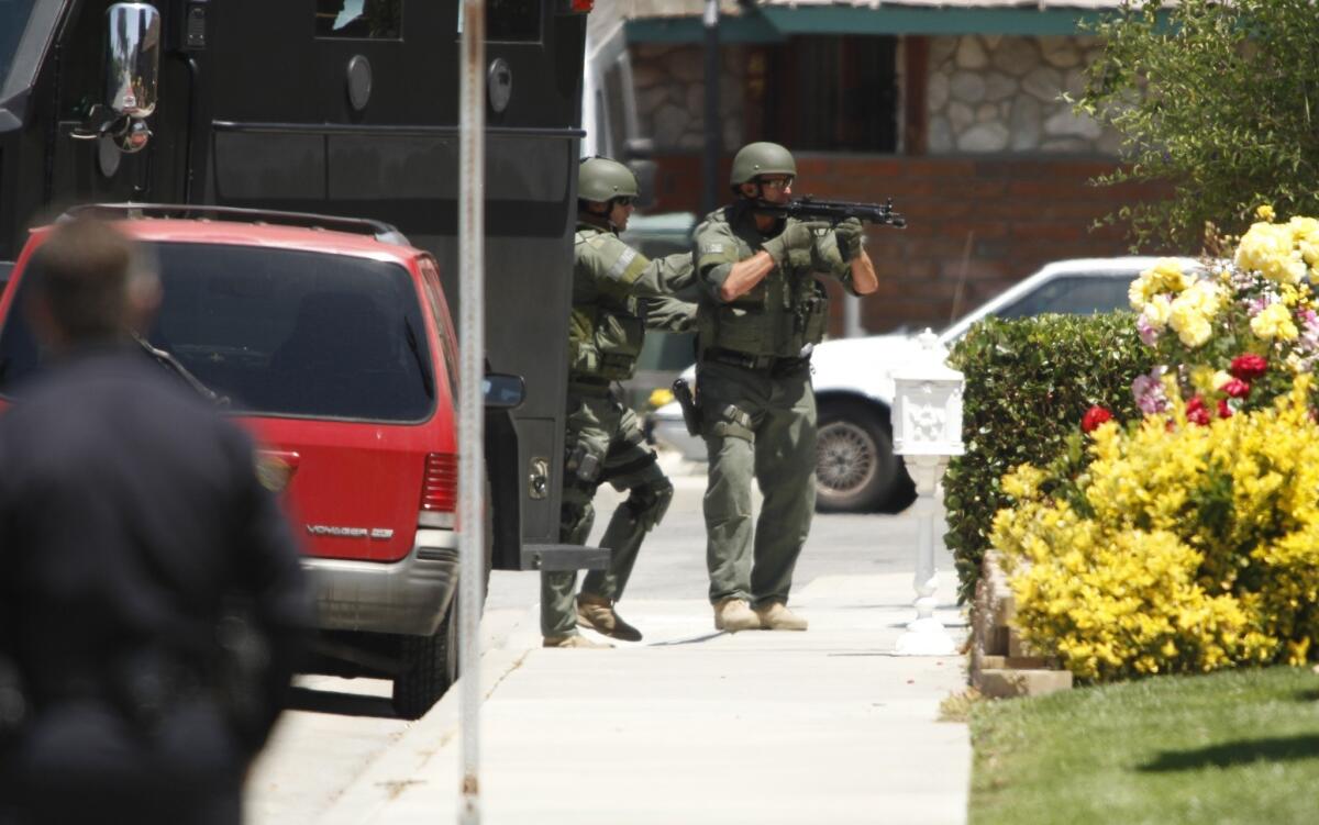 Huntington Beach SWAT officers prepare to enter a home in May 2011 in which police believed two people died in a murder-suicide.