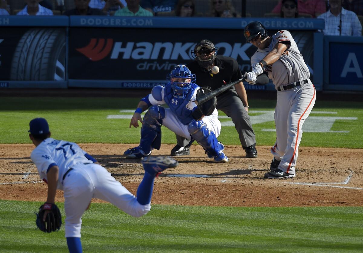 San Francisco outfielder Justin Maxwell hits a two-run home run off of Carlos Frias during the fifth inning of a game Saturday. The Dodgers lost to the Giants, 6-2.
