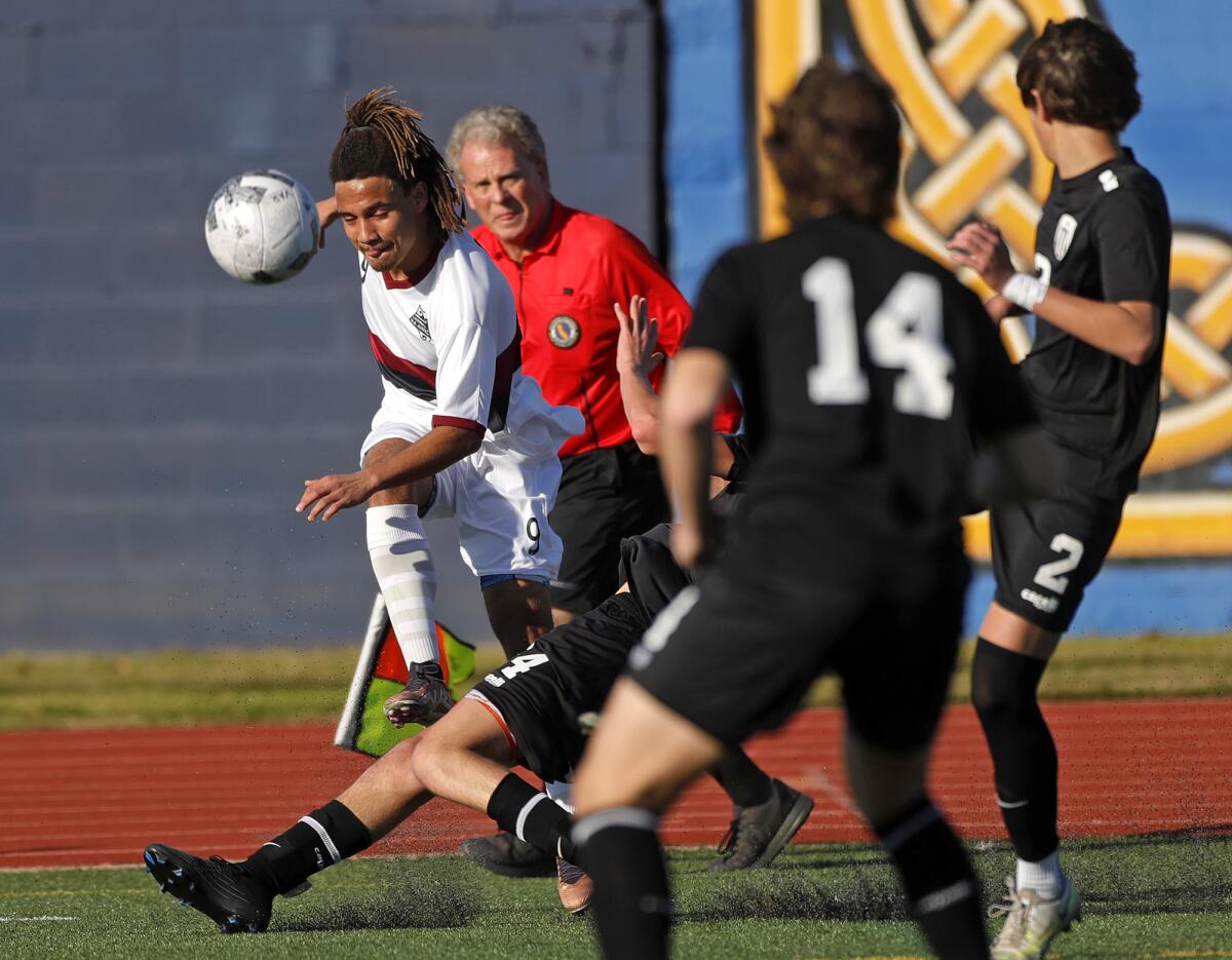 Jackson Rodriguez of Laguna Beach shoots the ball in traffic against Marina on Friday.