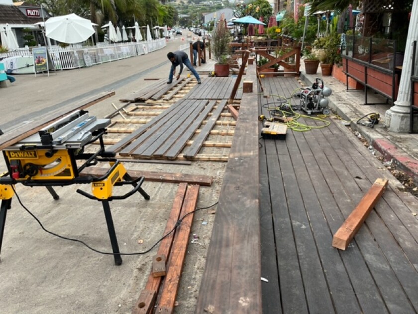 Restaurants in La Jolla Shores work July 18 to reduce their street dining space to comply with new requirements.
