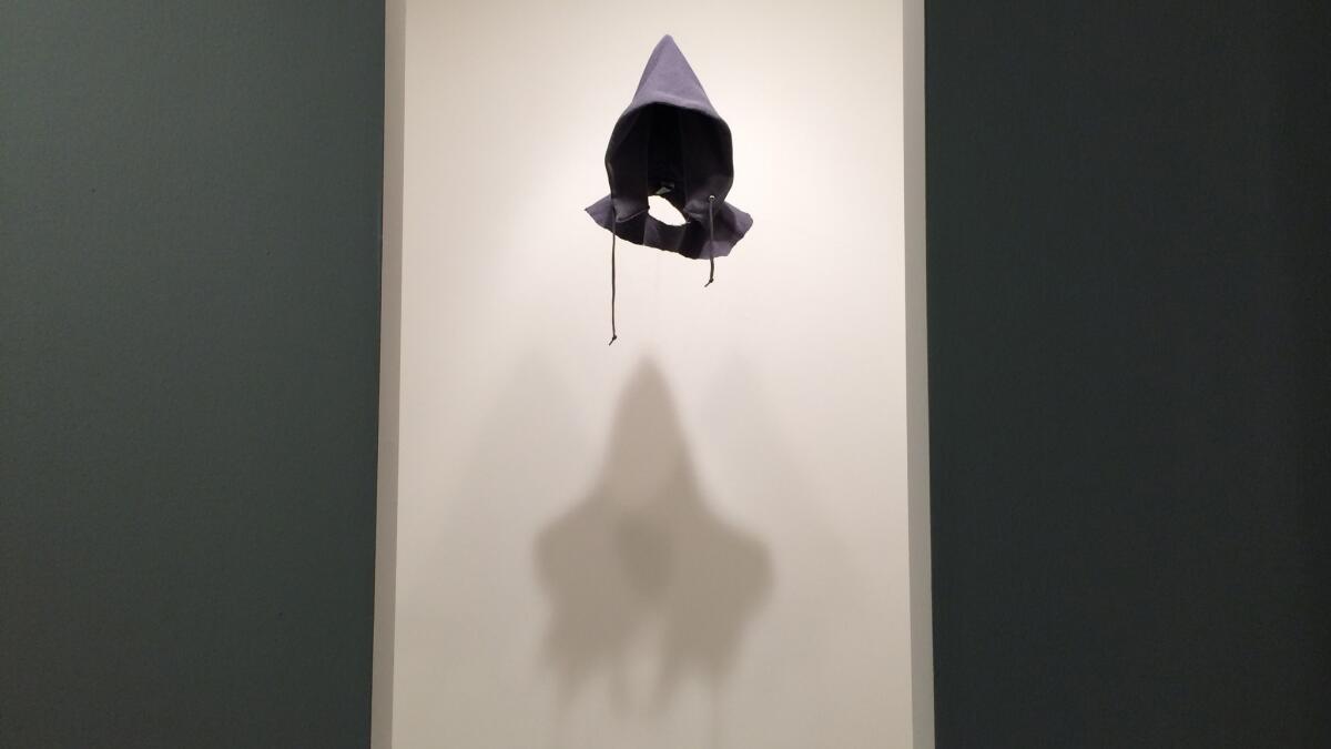 Ghost-like in its own little chamber is "In the Hood (Gray)," 2016, by David Hammons.