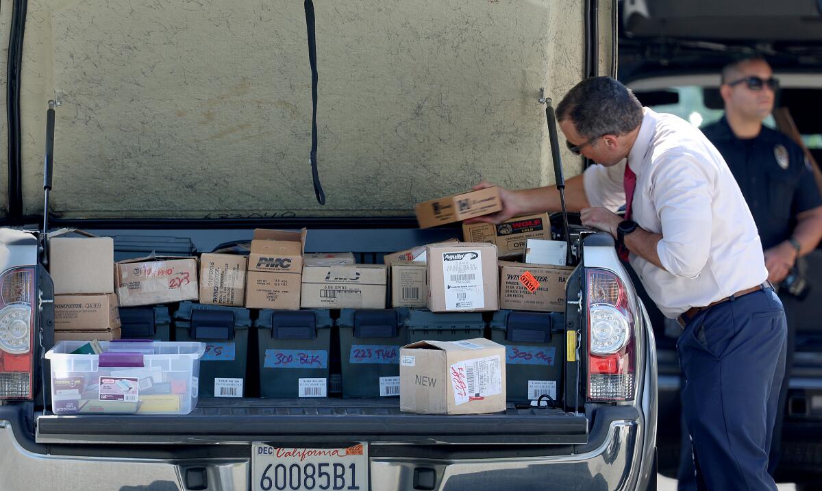Investigators load boxes of ammunition they removed from the home of Orange County Superior Court Judge Jeffrey Ferguson