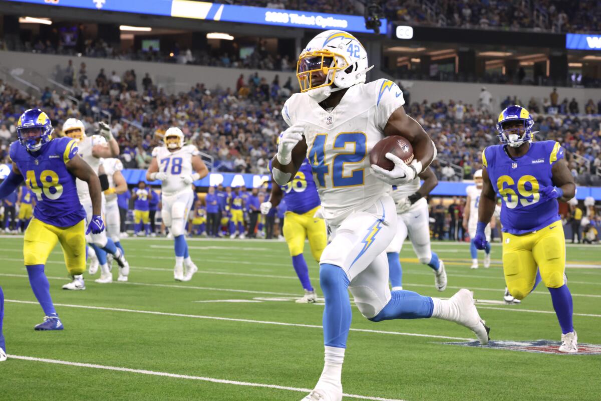 Chargers running back Elijah Dotson runs for one of two touchdowns against the Rams in a preseason game.