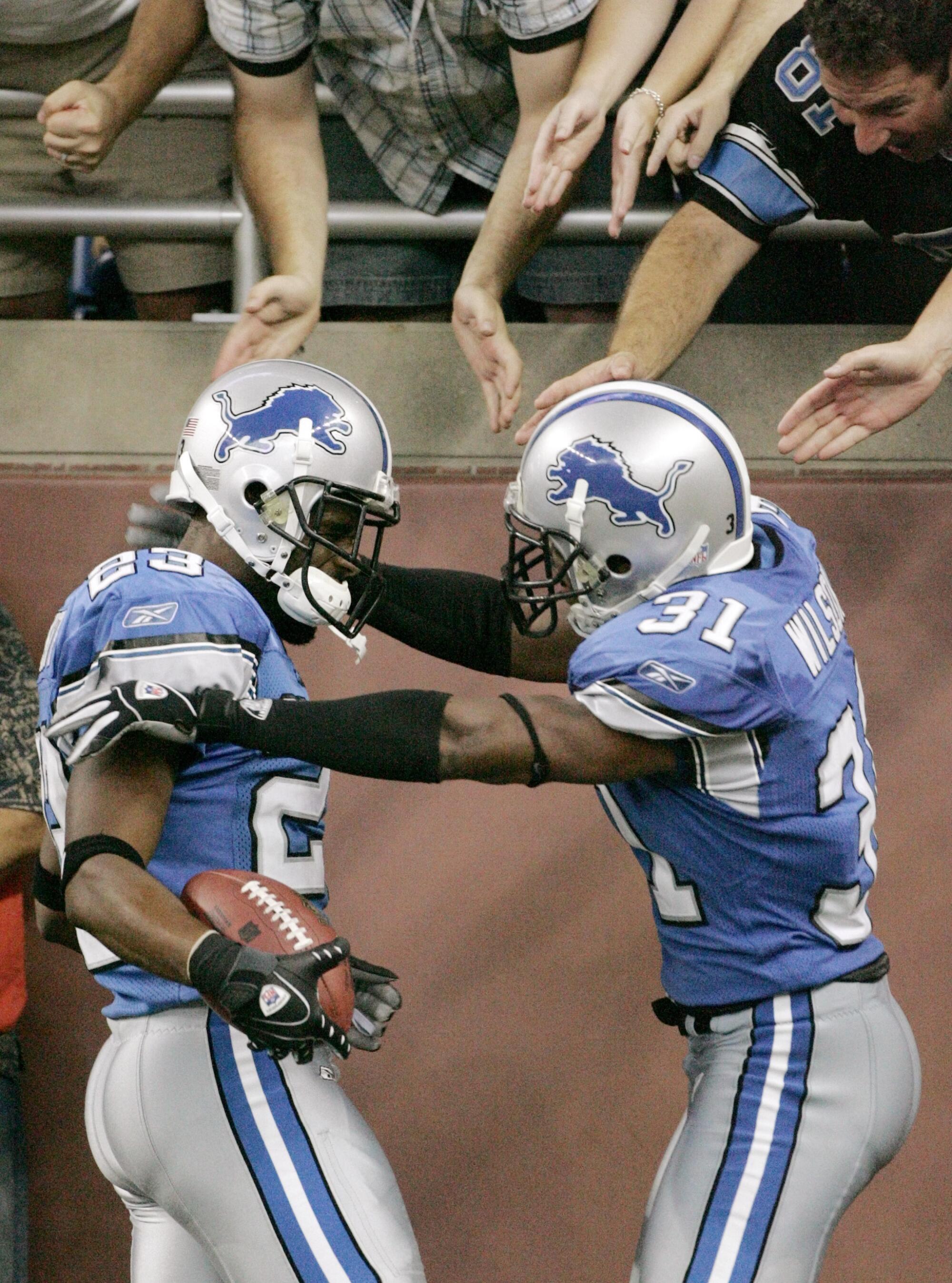 Lions cornerback Keith Smith, left, celebrates his touchdown with Stanley Wilson Jr. during a game against the Bears.