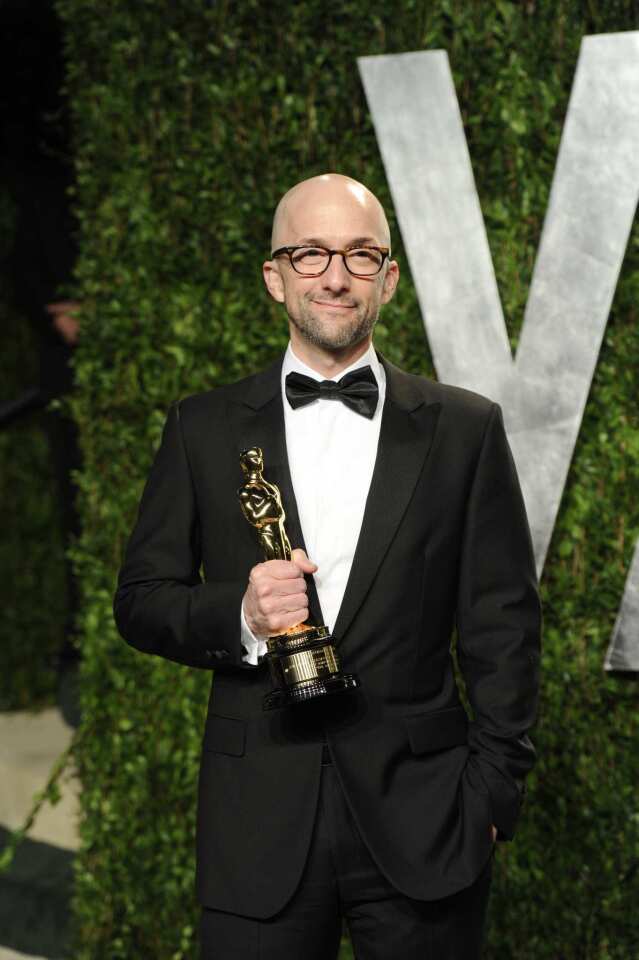 "Community" actor and "The Descendants" screenwriter Jim Rash holds his Oscar for adapted screenplay.