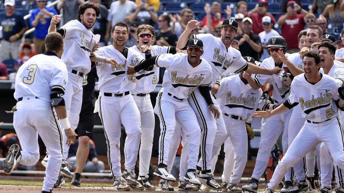 Vanderbilt's Jeren Kendall, left, approaches home plate after hitting a walk-off, two-run home run in the ninth inning to lift the Commodores to a 4-3 victory over Cal State Fullerton at the College World Series on Monday.