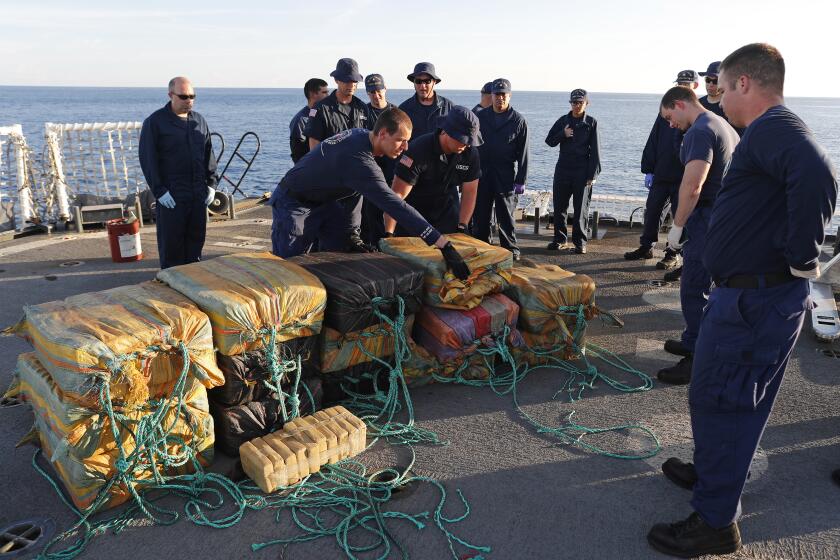 In this Feb. 23, 2017 photo, the crew from the U.S. Coast Guard cutter Stratton gather bales of cocaine that were seized from a small fishing boat. Four men were arrested caught smuggling some 700 kilos in the Pacific Ocean, hundreds of miles south of the Guatemala-El Salvador border. The Coast Guard set a record in 2016, seizing more than 240 tons of cocaine, however, that same year, the amount of land devoted to coca cultivation in Colombia climbed 18 percent. That is more coca production than at any time since the U.S. in 1999 began investing billions in an anti-narcotics strategy known as Plan Colombia. (AP Photo/Dario Lopez-Mills)