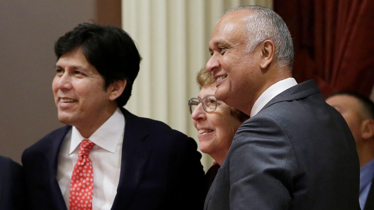 State Sen. Ed Hernandez of Azusa, right, smiles as he joins Senate President Pro Tem Kevin de León and then-Sen. Lois Wolk of Davis in 2016. (Rich Pedroncelli / Associated Press)