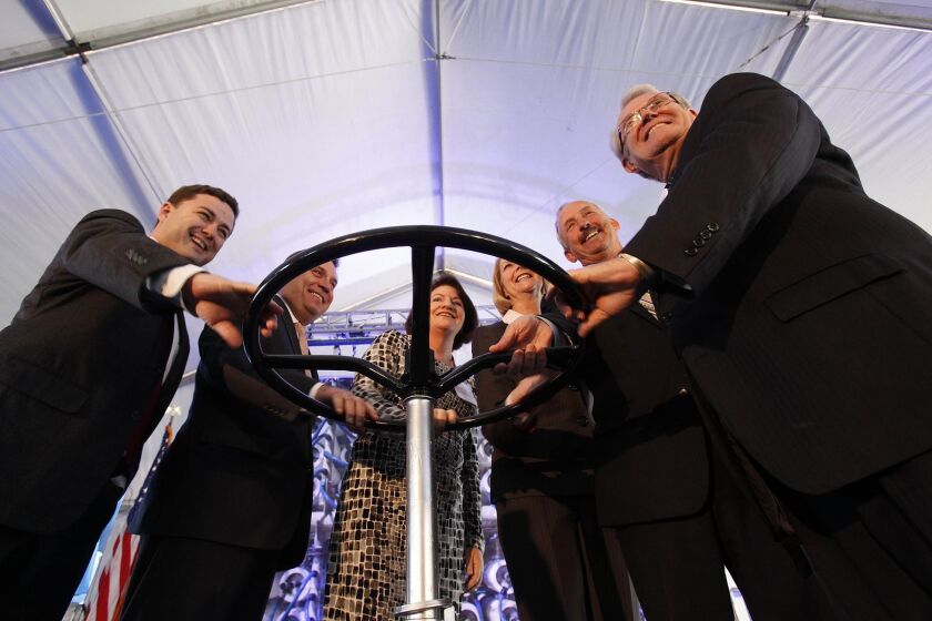 With Assembly Speaker Toni Atkins in the center, political and civic leaders turn a wheel to mark the ceremonial opening of the Claude "Bud" Lewis Desalination Plant. To the right of Atkins in the photo is Maureen Stapleton, general manager of the San Diego County Water Authority. To the right of Stapleton is Mark Weston, the authority's chairman.