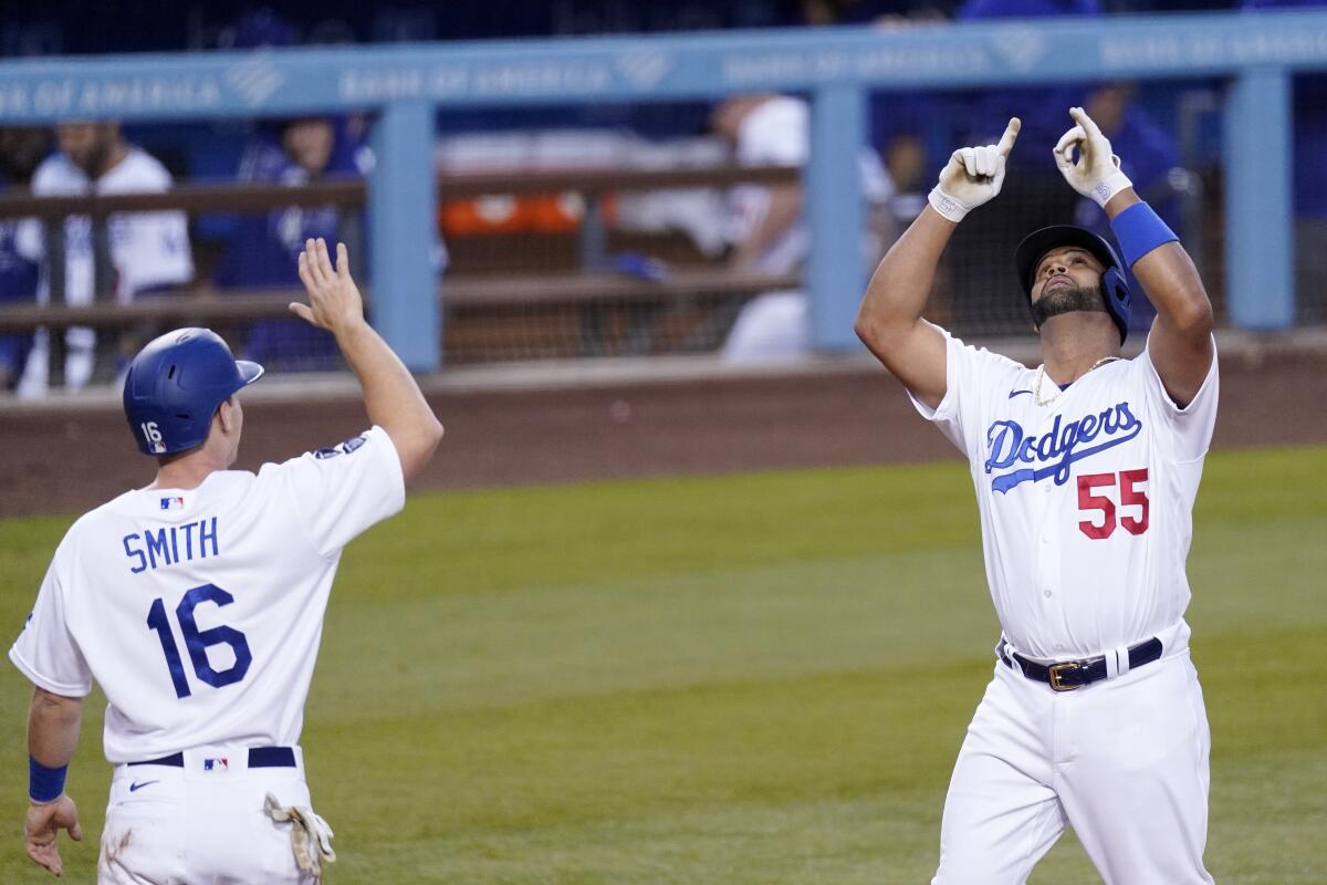 Dodgers first baseman Albert Pujols, right, is congratulated by Will Smith after hitting a two-run home run.