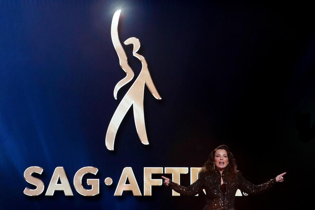 SAG-AFTRA President Fran Drescher onstage next to a large SAG-AFTRA logo