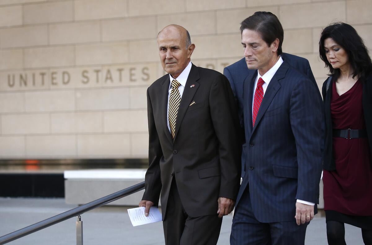 Former Los Angeles County Sheriff Lee Baca, left, with his attorney and his wife, emerges from court after being convicted.