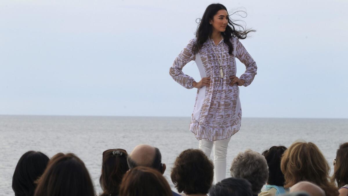 A model displays her outfit during an Artizara fashion show Sunday in Encinitas.