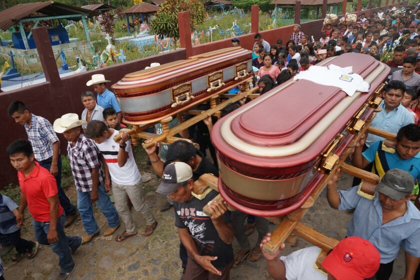 Family members, High school students, parishioners and neighbors sing and wave goodbye to cousins Delfino Cash Lopez 19 , and of Felix Cash Lopez 17 as they leave their home together .Both perished together in the truck accident in Chiapas Mexico Mexico , and were buried together . On March 12th,2019 residents of Aldea Nica a village in the province of San Marcos Guatemala, held memorial services and funerals for 7 of the 23 US-bound migrants who died on March 7 when a small smuggling truck filled with 70 migrants crashed in southern Mexico.