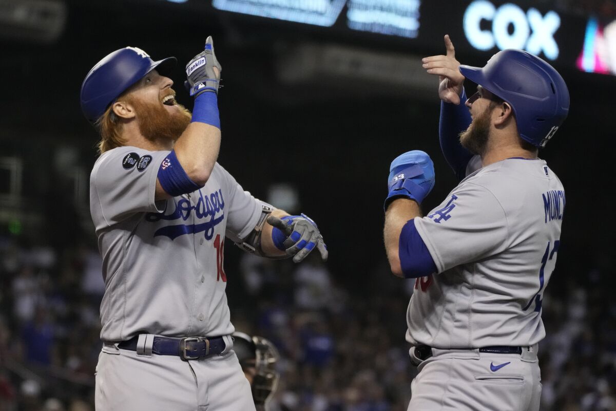 The Dodgers' Justin Turner, left, celebrates with Max Muncy after Turner's two-run homer.