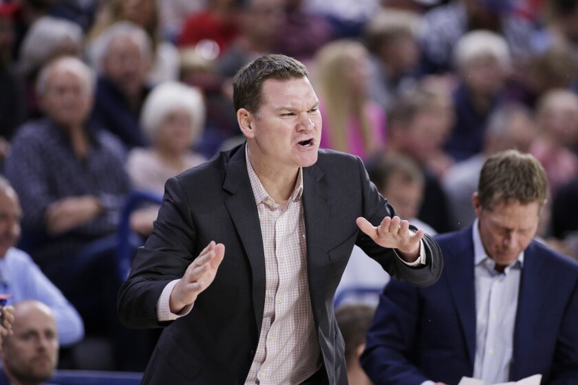 FILE - Gonzaga assistant coach Tommy Lloyd shouts to his players during the first half of an NCAA college basketball game against Texas-Arlington in Spokane, Wash., in this Tuesday, Nov. 19, 2019, file photo. Tommy Lloyd was in position to be Gonzaga's next basketball coach after Mark Few retired. A chance to coach at Arizona, one of the premier programs in the country, changed those plans. At right looking down is Mark Few. (AP Photo/Young Kwak, File)
