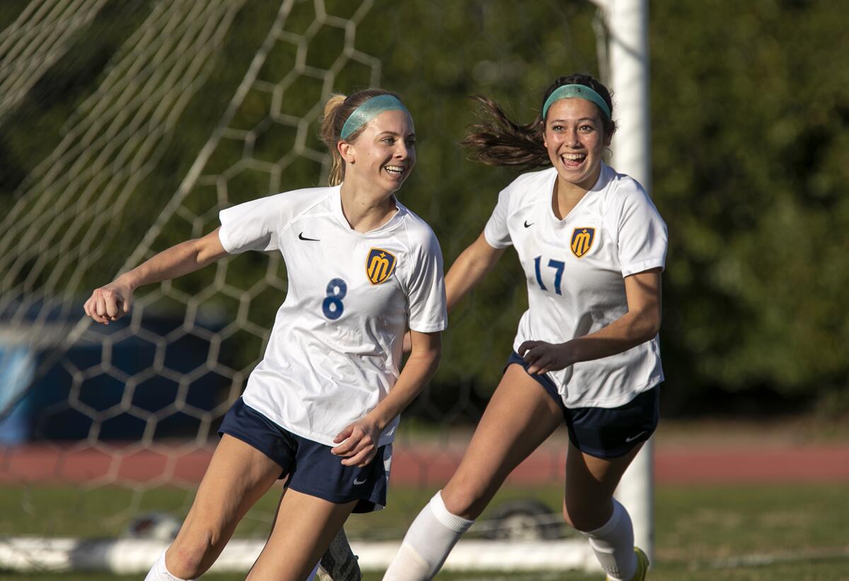 Marina's Kendall Crosby, left, and Aspen Castillo celebrate after Crosby scores a goal against Bishop Amat on Friday.