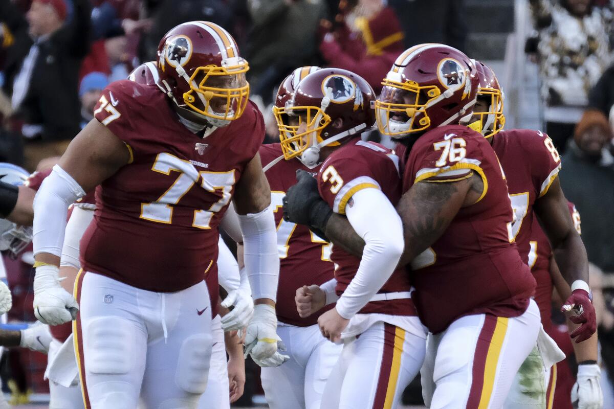 Washington Redskins kicker Dustin Hopkins, center, is congratulated by offensive guard Ereck Flowers, left, and offensive tackle Morgan Moses after kicking a field goal.