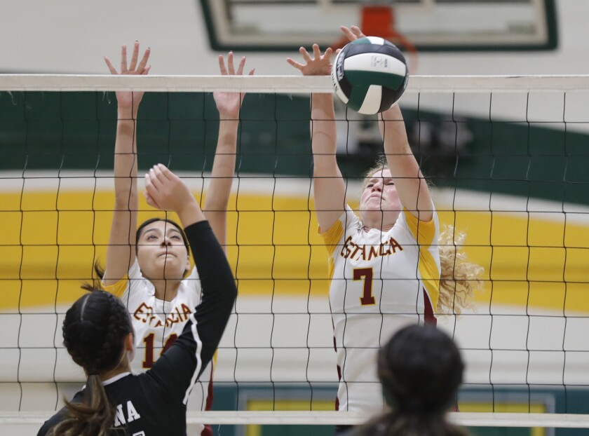 Estancia's Ruby Uchytil (7) blocks a shot with Natalie Aguayo (14) against Rancho Alamitos Thursday.