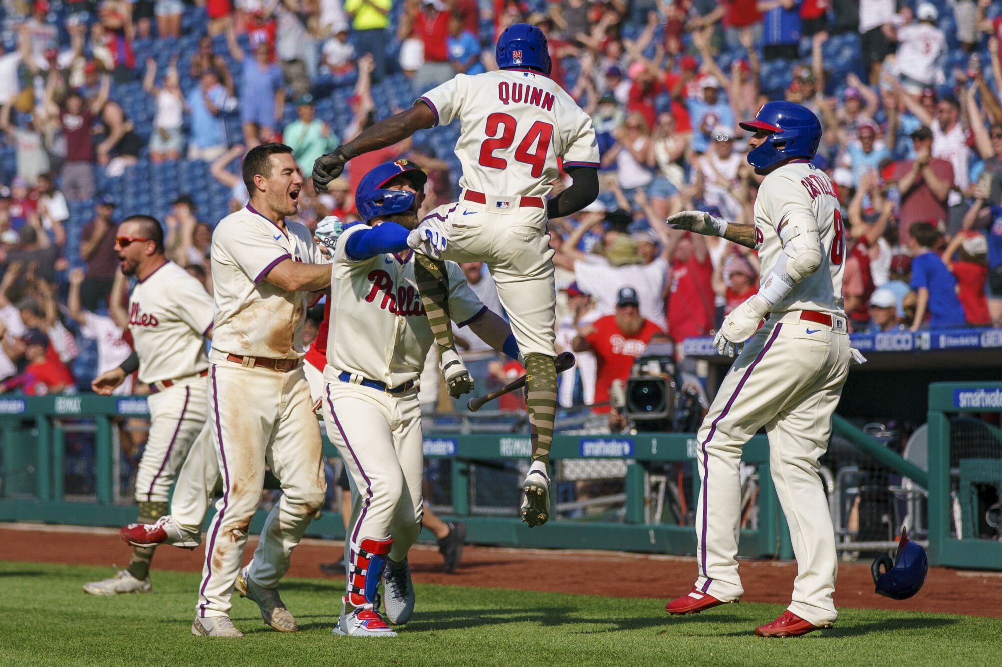 Philadelphia's Roman Quinn, center, celebrates with teammates after scoring the winning run against the Dodgers.