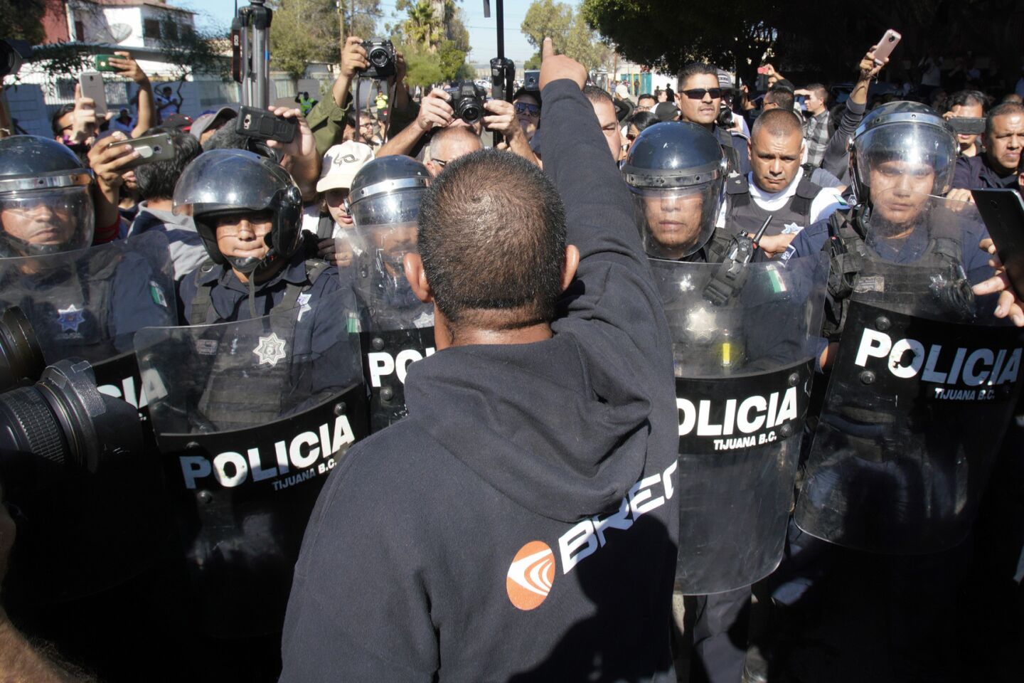 Anti-caravan protest starts peaceful, turns tense outside Tijuana shelter