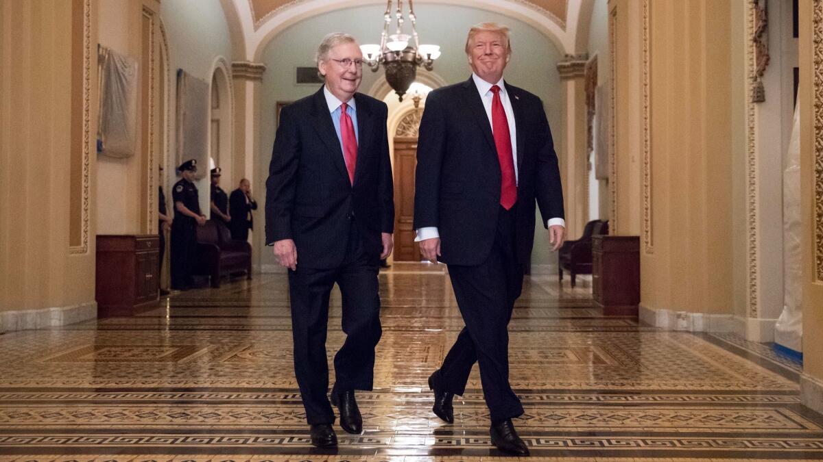 President Trump, escorted by Senate Majority Leader Mitch McConnell (R-Ky.), arrives on Capitol Hill to have lunch with Senate Republicans and discuss tax reform on Oct. 24.