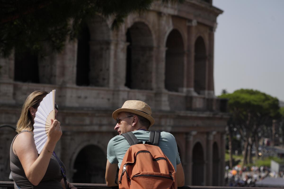 Tourists in front of the Colosseum in Rome