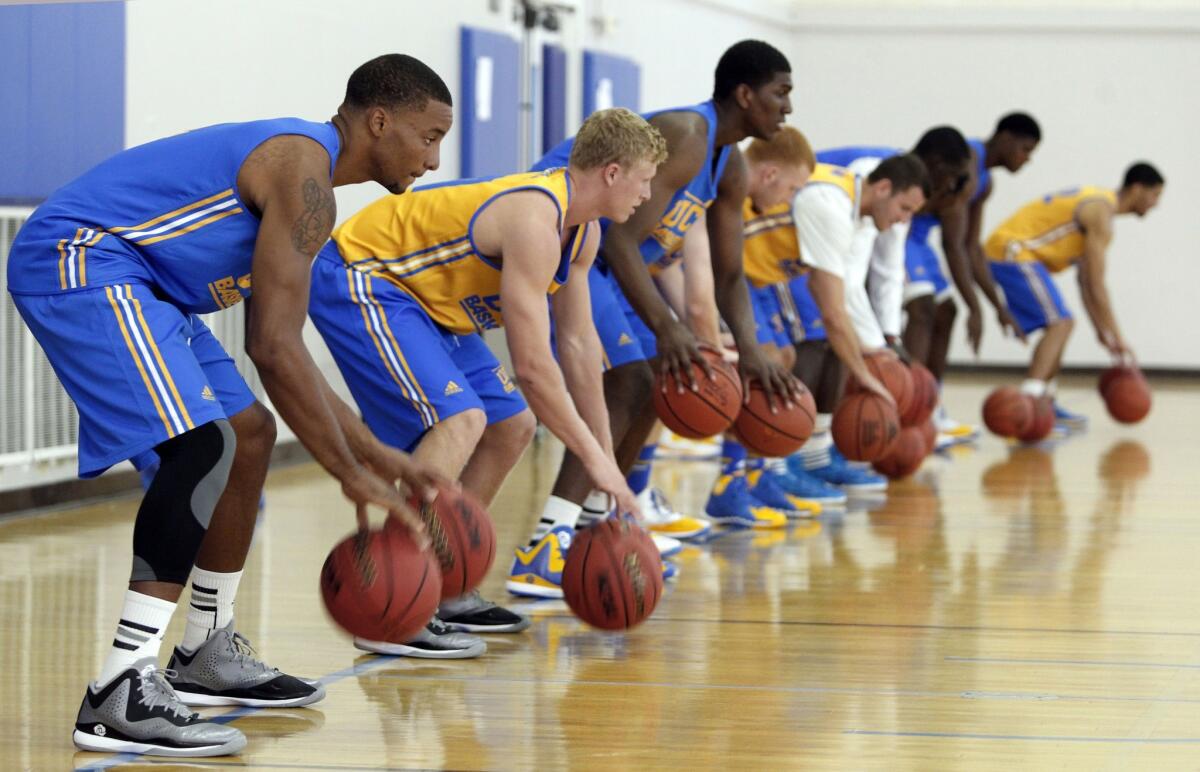 UCLA guard Normal Powell, left, dribbles a ball with his Bruins teammates during an Oct. 14 practice on media day.