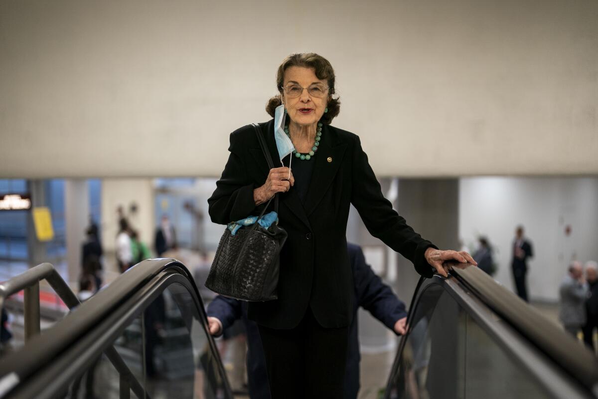 Dianne Feinstein ascends an escalator.