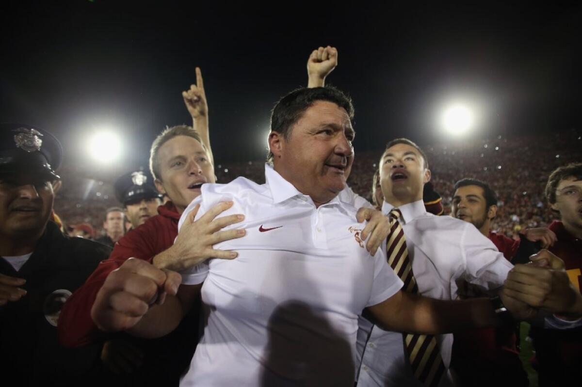 Ed Orgeron is surrounded by well-wishers after USC upset Stanford.