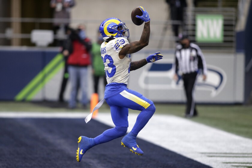 Los Angeles Rams running back Cam Akers reacts after scoring on a 5-yard run against the Seattle Seahawks during the first half of an NFL wild-card playoff football game, Saturday, Jan. 9, 2021, in Seattle. (AP Photo/Scott Eklund)