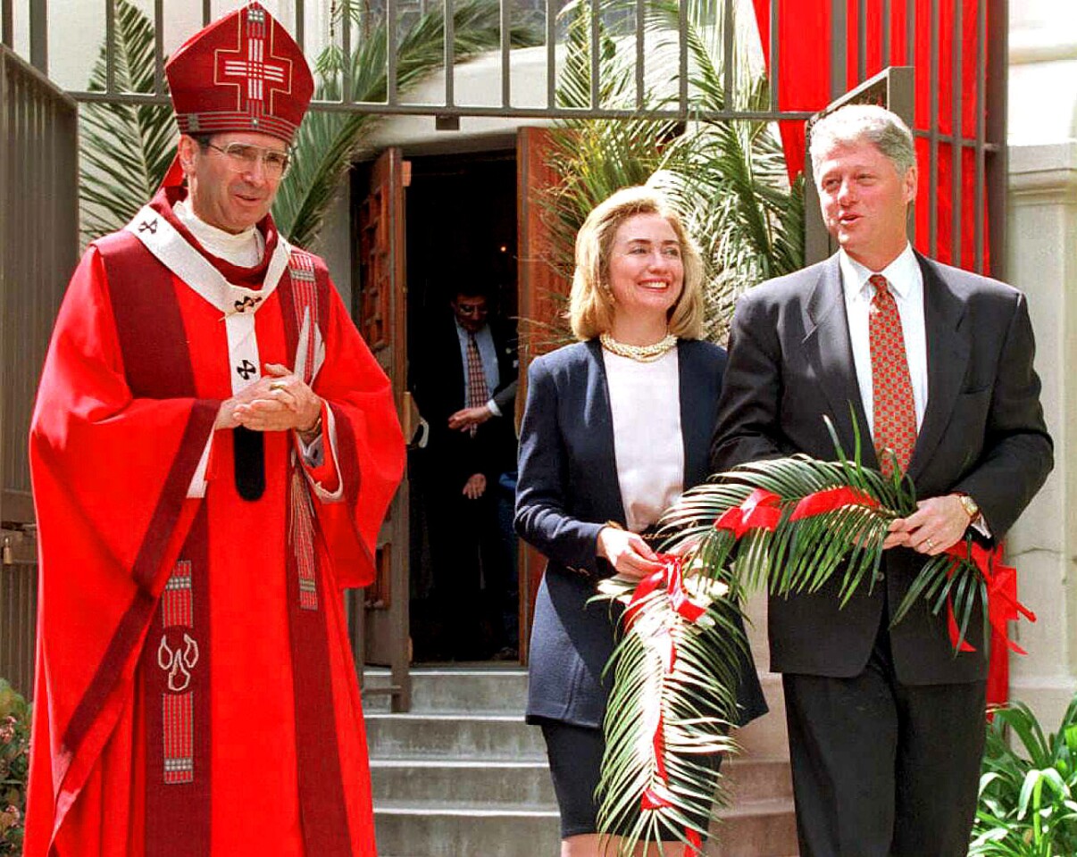 President Bill Clinton and First Lady Hillary Rodham Clinton attend a Catholic Palm Sunday service in Los Angeles with Cardinal Roger Mahony in 1995.
