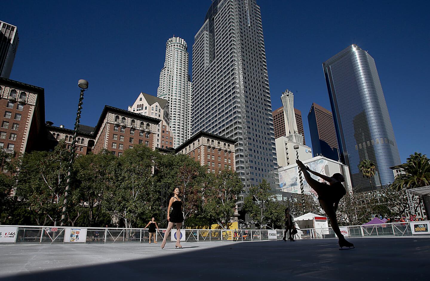 Figure skaters perform during the opening of the 16th Annual Downtown On Ice outdoor skating rink at Pershing Square.