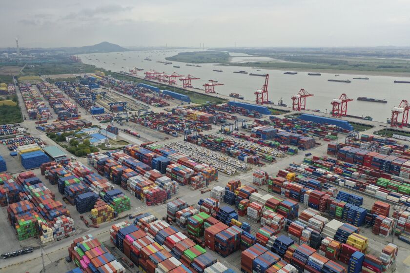 FILE - Containers are seen at a port in Nanjing in eastern China's Jiangsu province on Oct. 27, 2022. China’s imports and exports shrank in November as global demand weakened and anti-virus controls weighed on the second-largest economy. (Chinatopix via AP, File)