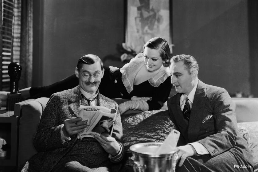 1932: Joan Crawford (1904 - 1977) John Barrymore (1882 - 1942) and Lionel Barrymore (1978 - 1954, left) star in the movie 'Grand Hotel', directed by Edmund Goulding for MGM. (Photo via John Kobal Foundation/Getty Images)