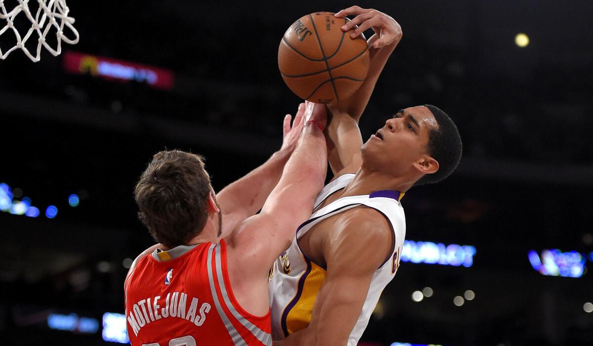 Lakers guard Jordan Clarkson tries to score on a layup against Rockets forward Donatas Motiejunas in the first half.