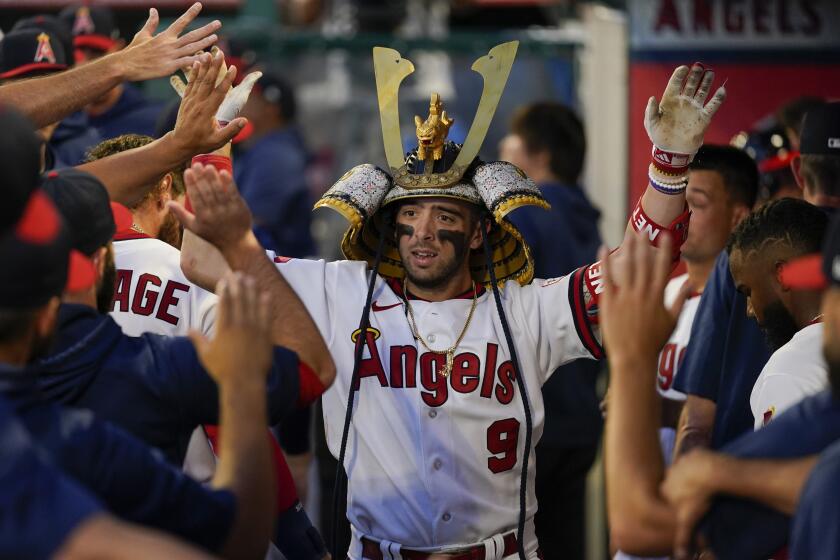 Los Angeles Angels' Zach Neto (9) celebrates in the dugout after hitting a home run during the fifth inning.